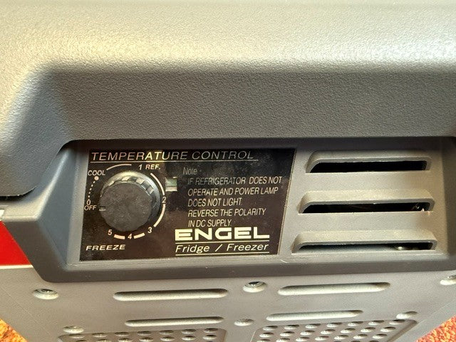 Close-up of the temperature control dial and instruction label on the Engel MR040 Top Opening Fridge-Freezer by Engel Coolers, displaying settings from cool to freeze—engineered with corrosion-resistant materials to ensure reliable performance in marine environments.
