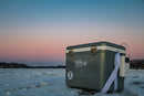 A Engel Coolers equipped with a stainless steel hardware sitting on top of a frozen lake.