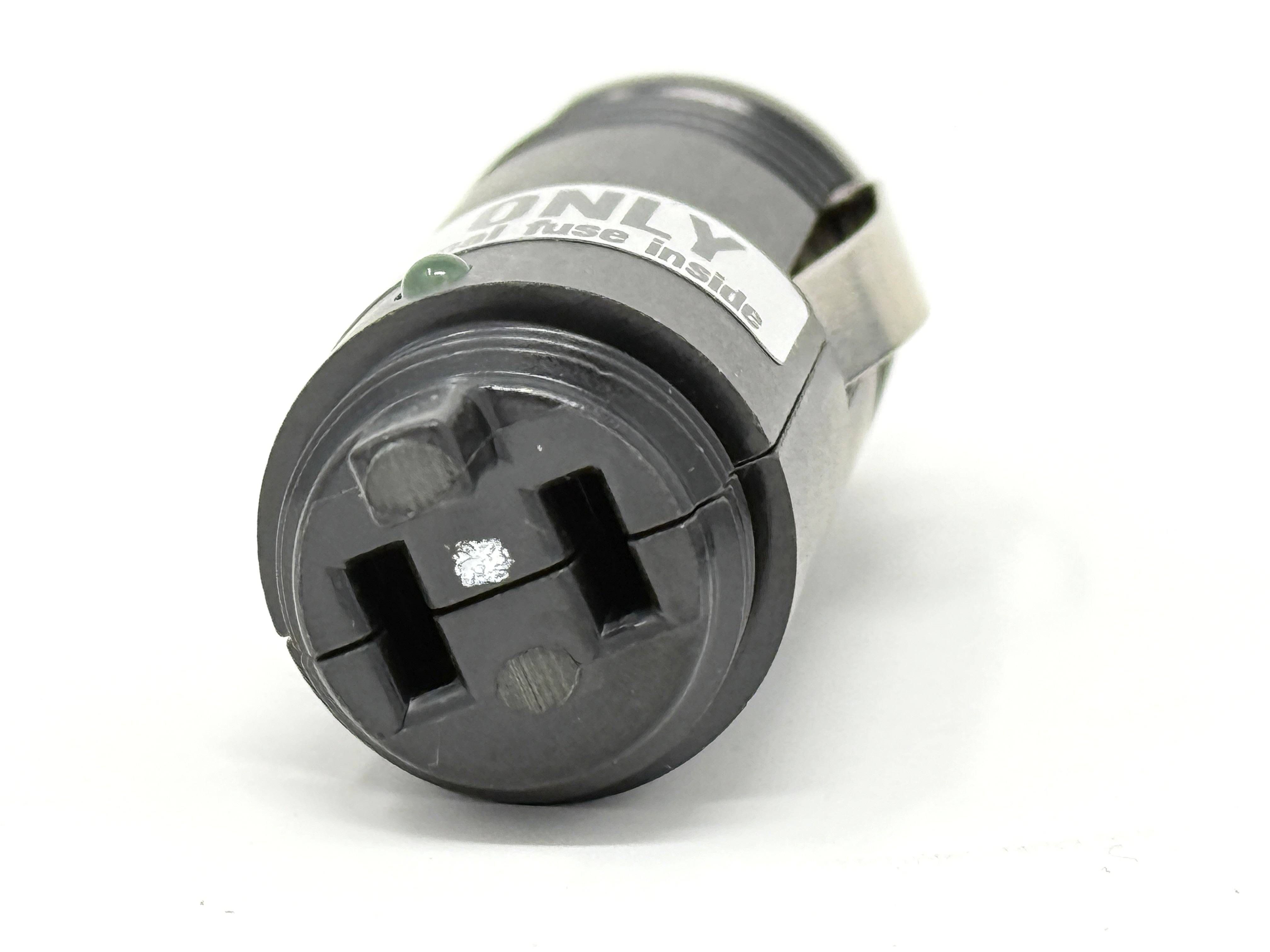 Close-up of a cylindrical fuse holder with labeled slots for connections, shown on white background—ideal replacement part for Engel Coolers DC Plug Assembly 12/24V outlets.