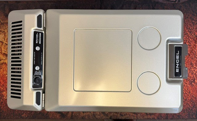 Top view of an Engel Coolers MT45 Platinum Series portable fridge-freezer with a control panel, two circular indents, and a black handle displaying the Engel Coolers logo, equipped with the dependable Swing Motor Compressor for efficient cooling.