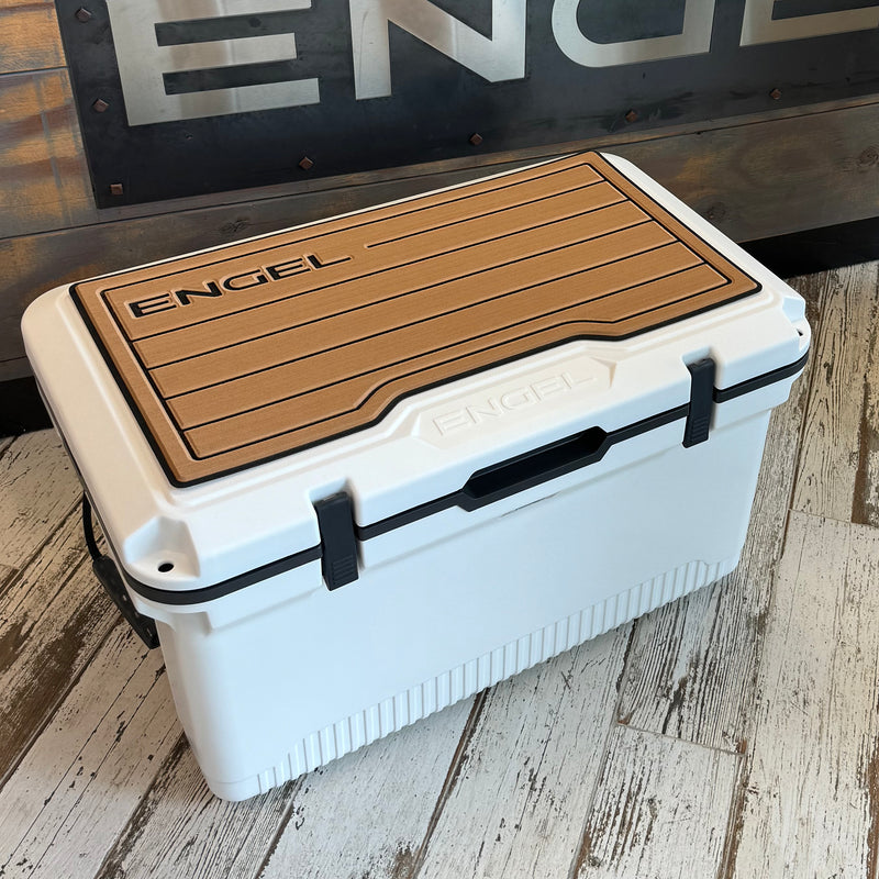 An UL60 SeaDek® Non-Slip Marine Cooler Topper by Engel Coolers on a wooden floor.