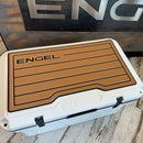 A Engel Coolers cooler with the word "engel" on it and UL60 SeaDek® Non-Slip Marine Cooler Topper pads.