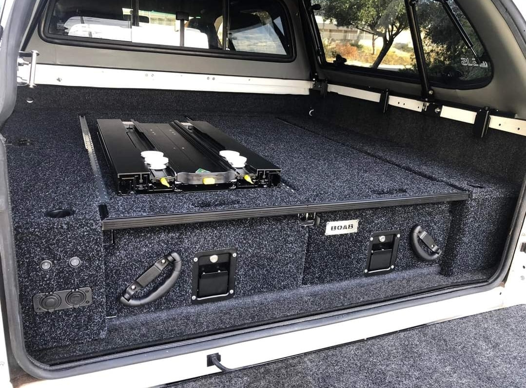The back of a truck with an ENGEL Standard Low-Profile Front Pull Fridge Slide storage compartment.