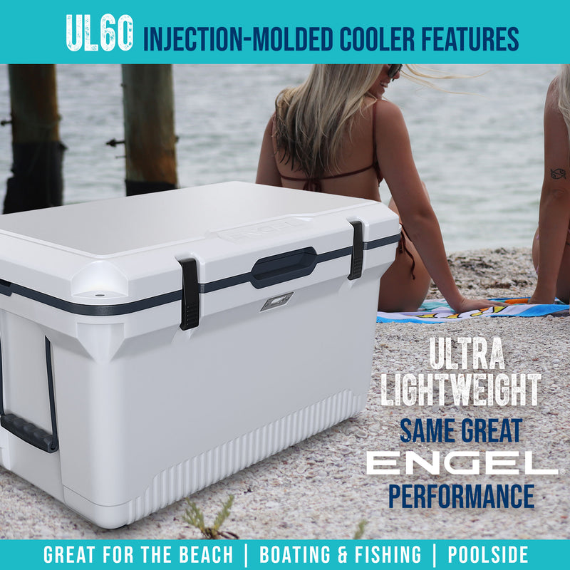 A woman is sitting on the beach with an Engel Coolers ENGEL 60QT UltraLite Injection-Molded Cooler With Wire Basket and Divider.