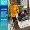 Two children playing outside in the rain; one standing in a yellow raincoat, the other sitting in an Engel Coolers 13 Quart Drybox/Cooler.