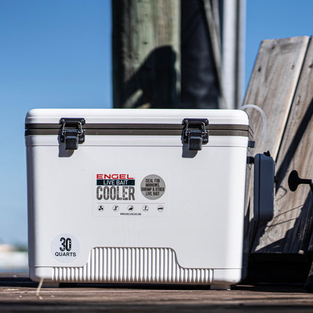A white cooler sitting on a dock.
