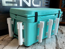 A turquoise Engel cooler with white handles and a Rod Holder Stand-Off Surface Mount attachment on it.