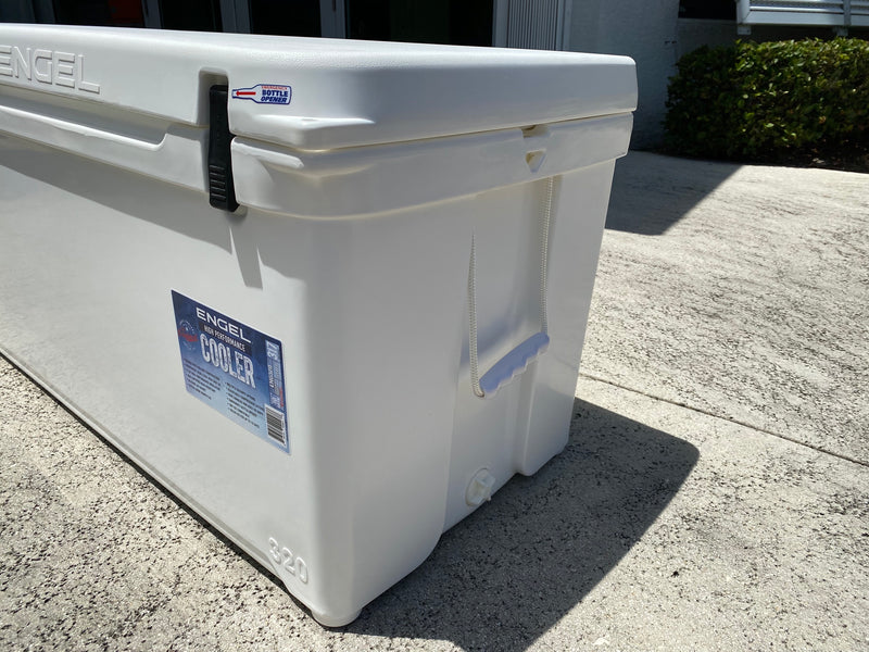 A white Engel 320 High Performance Hard Cooler and Ice Box by Engel Coolers sitting on a sidewalk.