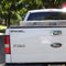 A white Ford F-150 pickup truck with the Engel Coolers black window decal on the back.