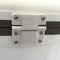 A close up of a white Engel Coolers plastic drybox hinge with stainless steel latches.