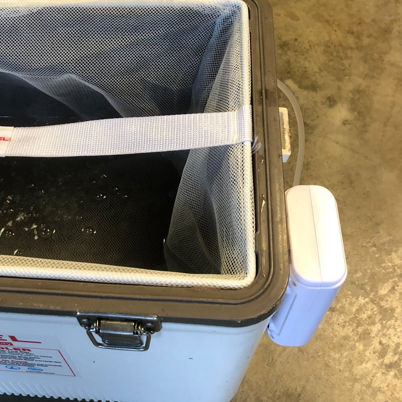 A Engel cooler with a Engel Extra Large Lithium-ion Rechargeable Live Bait Aerator Pump and a plastic bag attached to it for live bait.