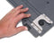 A person's hand is holding a metal plate with Engel Coolers Transit Slide Lock on a laptop for safety.