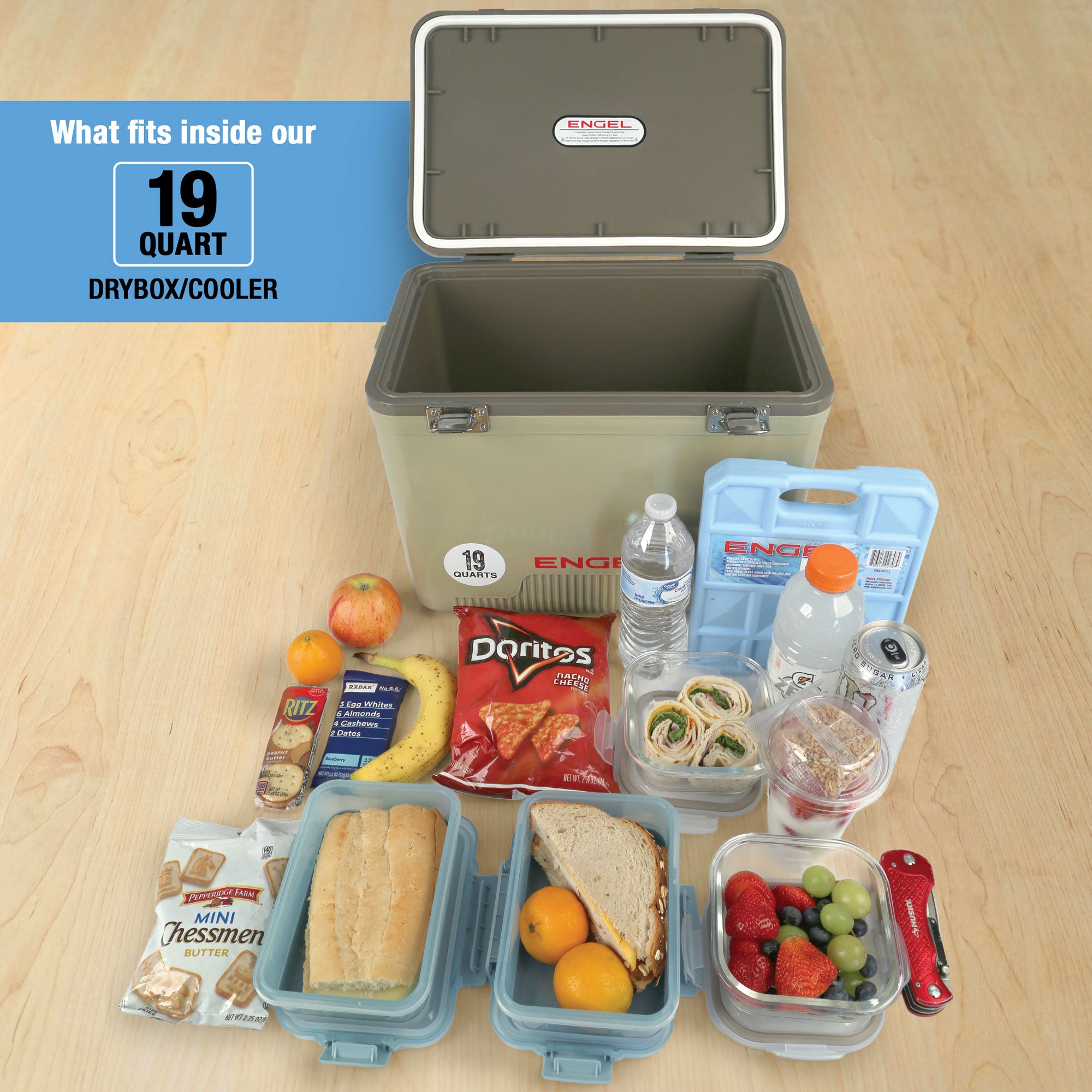 The Engel Coolers 19 Quart Drybox/Cooler with Rod Holders is shown open, with assorted food, drinks, and ice packs in front to demonstrate its capacity and leak-proof storage.