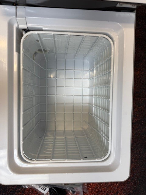 An empty Engel Coolers MT17F top-opening fridge-freezer is shown from above with the lid open and wire basket inside, featuring the efficient Engel Swing Motor Compressor. Works on 12/24V DC or 110/120V AC.