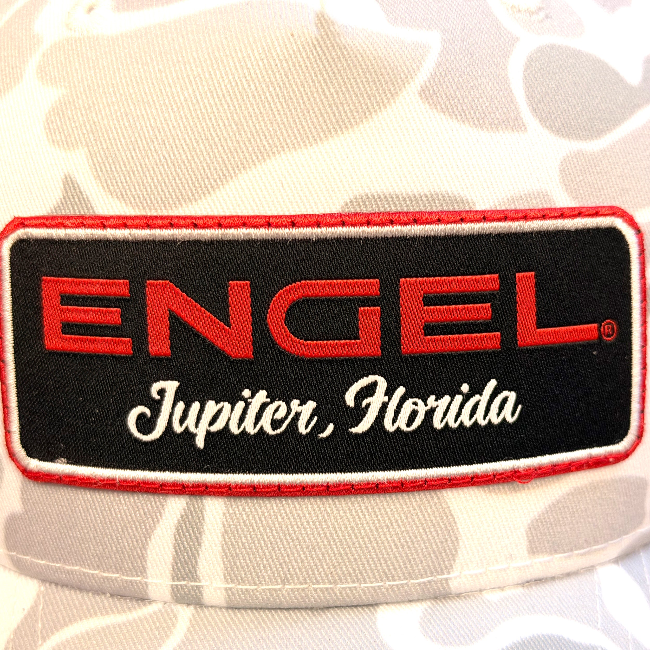 Close-up of the Engel patch featuring the text "ENGEL Jupiter, Florida" in red and white letters on a black background, as seen on the Engel Blizzard Duck Camo Richardson® 112 Trucker Cap by Richardson—perfect for adding unique style to your favorite trucker cap.