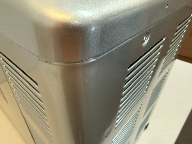 Close-up of a metallic computer case corner with ventilation slots and a visible scratch along the edge, reminiscent of the rugged durability found in Engel Coolers’ MT45 Combination Platinum Series Top Opening 12/24V DC -110/120V AC Fridge-Freezer, renowned for its robust Swing Motor Compressor technology.