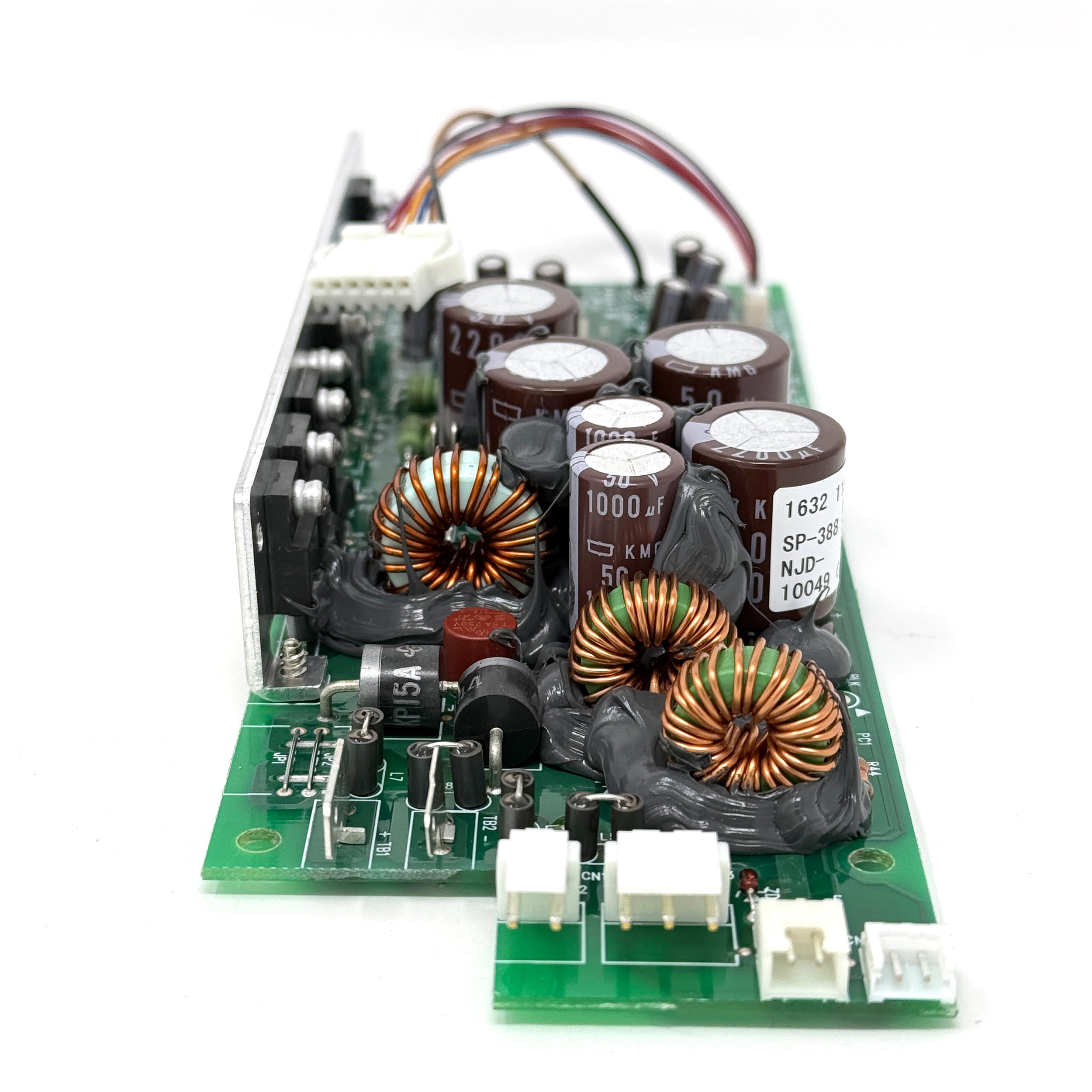 A close-up of an electronic circuit board with capacitors, coils, connectors, and wiring from the ENGEL MHD13F-DM Power Supply.