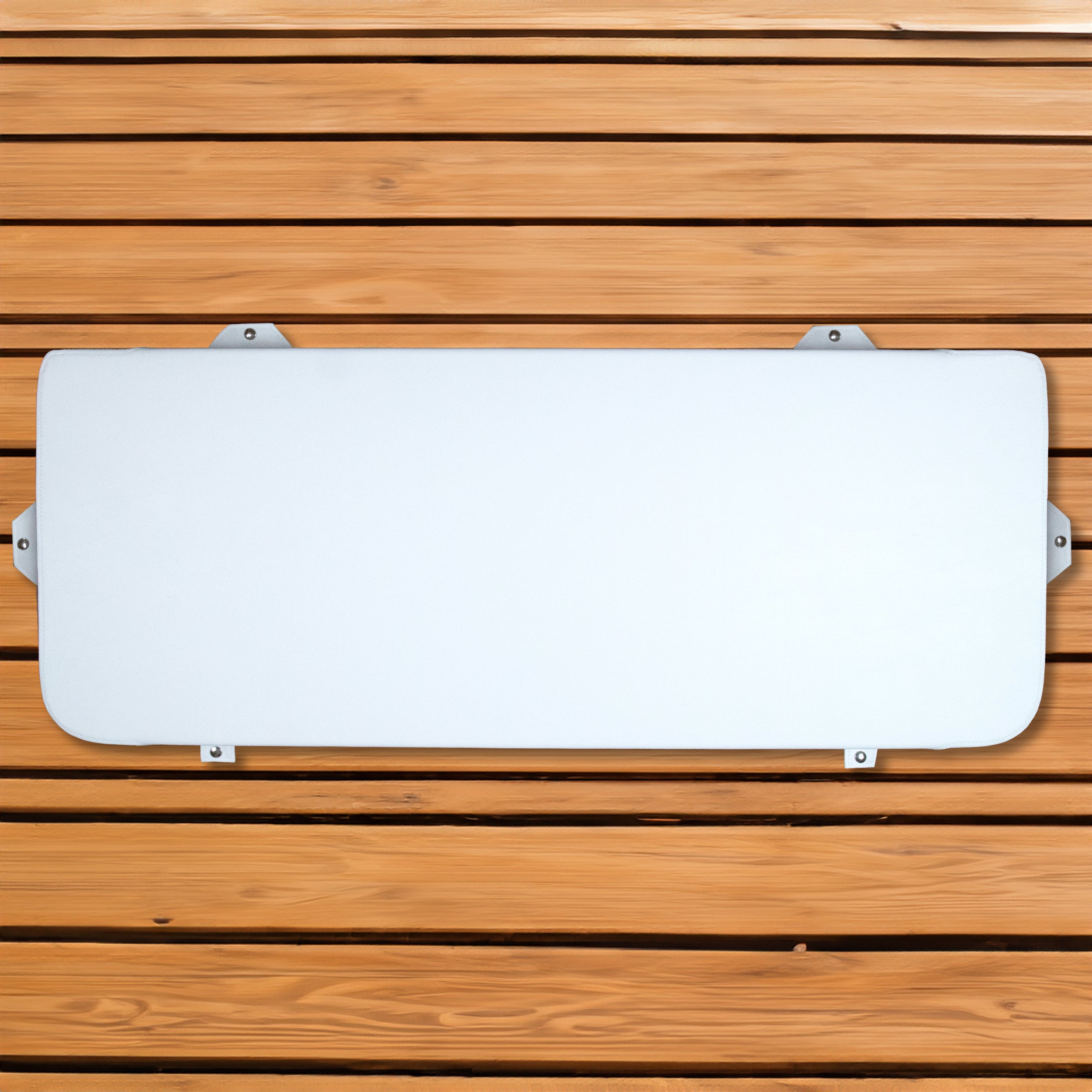 A white seat cushion for Engel Hard Cooler hanging on a marine-grade wooden wall.