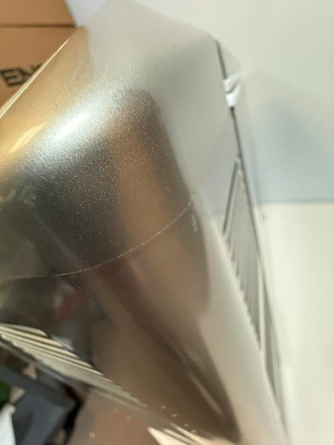 Close-up view of a metallic, rectangular object with a curved edge and vent-like slits on one side, identified as the Engel MT45 Platinum Series (Refurbished) portable fridge-freezer by Engel Coolers.