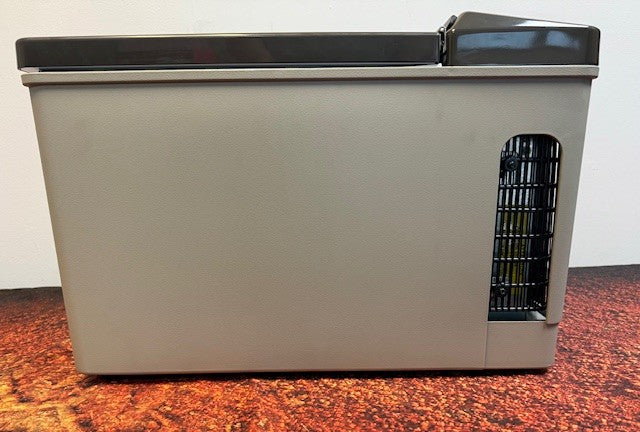 The Engel Coolers MT17F top-opening fridge-freezer in gray and black is shown from the side, featuring a vented section near the bottom right—perfect for keeping items cold on the go with 12/24V DC and 110/120V AC power options.