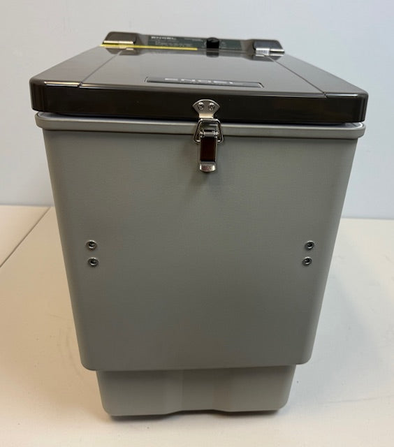 An Engel Coolers MT27 gray and black fridge-freezer storage container sits on a white surface, with a metal latch, reinforced corners, and variable temperature control for secure, customizable cooling.