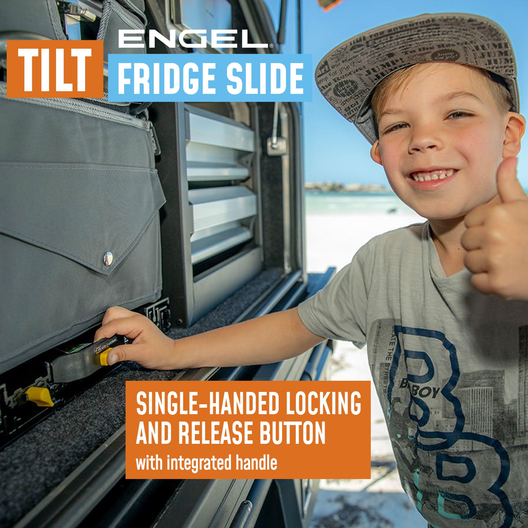 Young boy giving a thumbs-up next to an ENGEL Low-Profile Front-Pull Tilt Fridge Slide, an outdoor accessory with a single-handed locking and release button feature and innovative tilt mechanism.