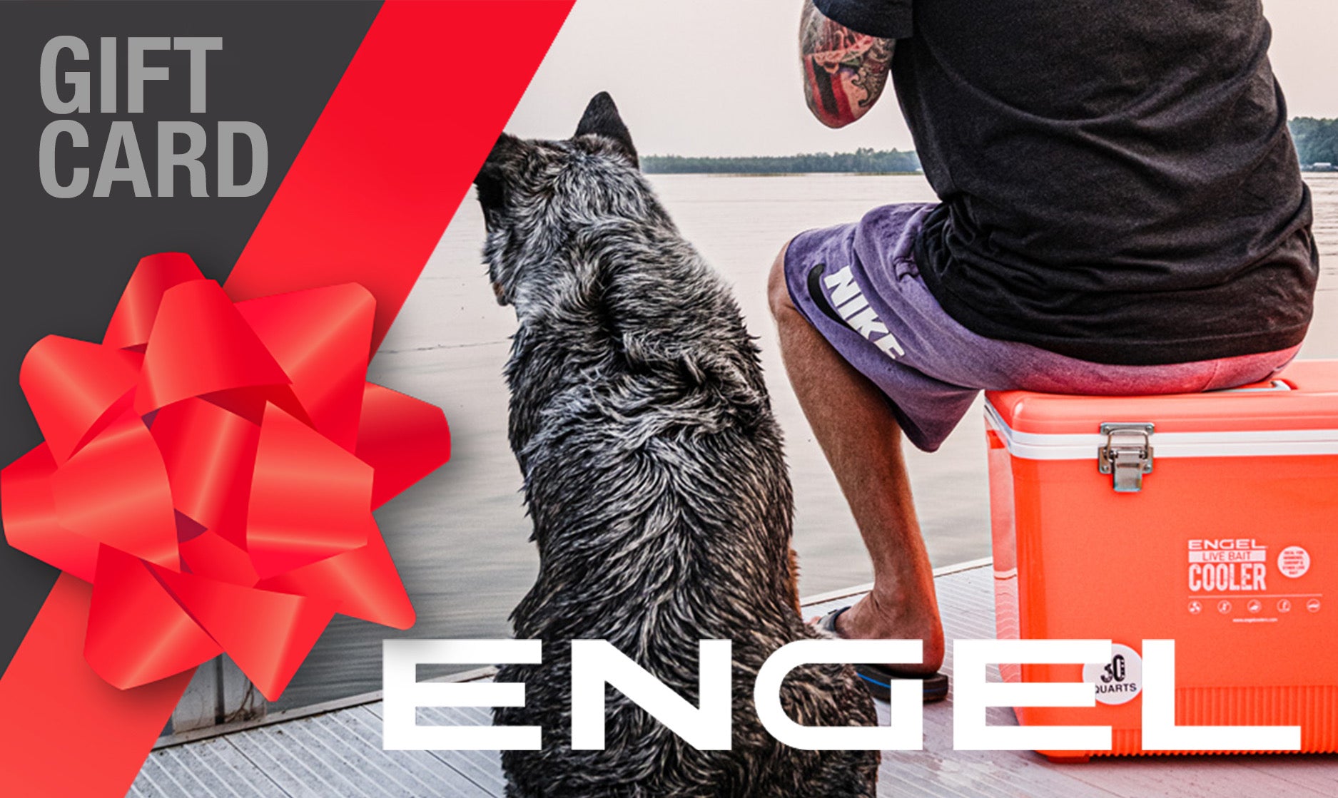 A person unwinds on the dock with their faithful dog and a bright orange cooler from Engel Coolers beside them, adorned with a large red bow. Use your Engel Coolers Gift Card today to unlock adventure-ready accessories and more!