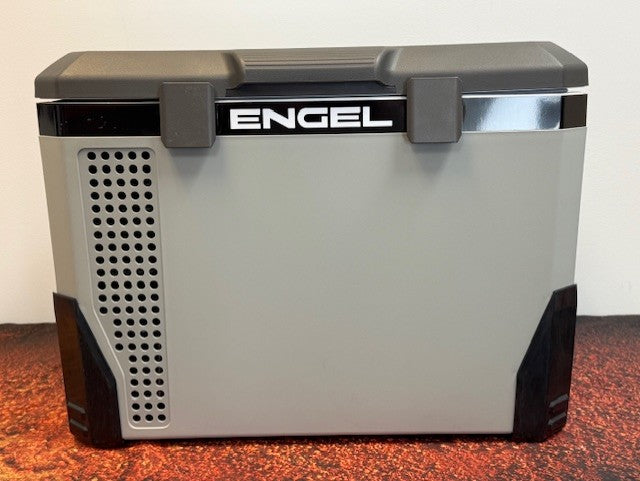 An Engel MR040 Top Opening Fridge-Freezer by Engel Coolers rests on a reddish-brown surface, its brand prominently shown—designed for corrosion resistance and perfect for marine environments.