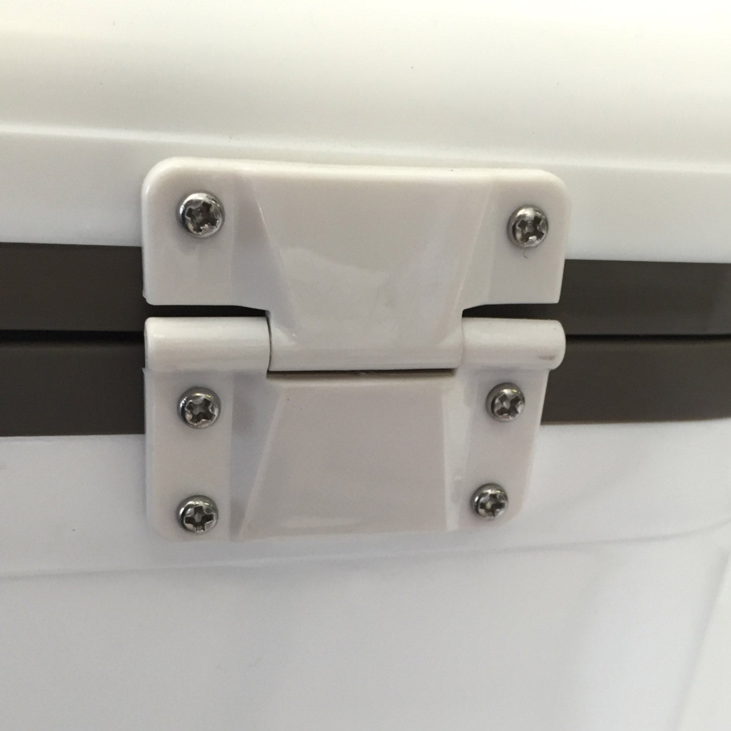 A close up of a white Engel Coolers plastic drybox hinge with stainless steel latches.