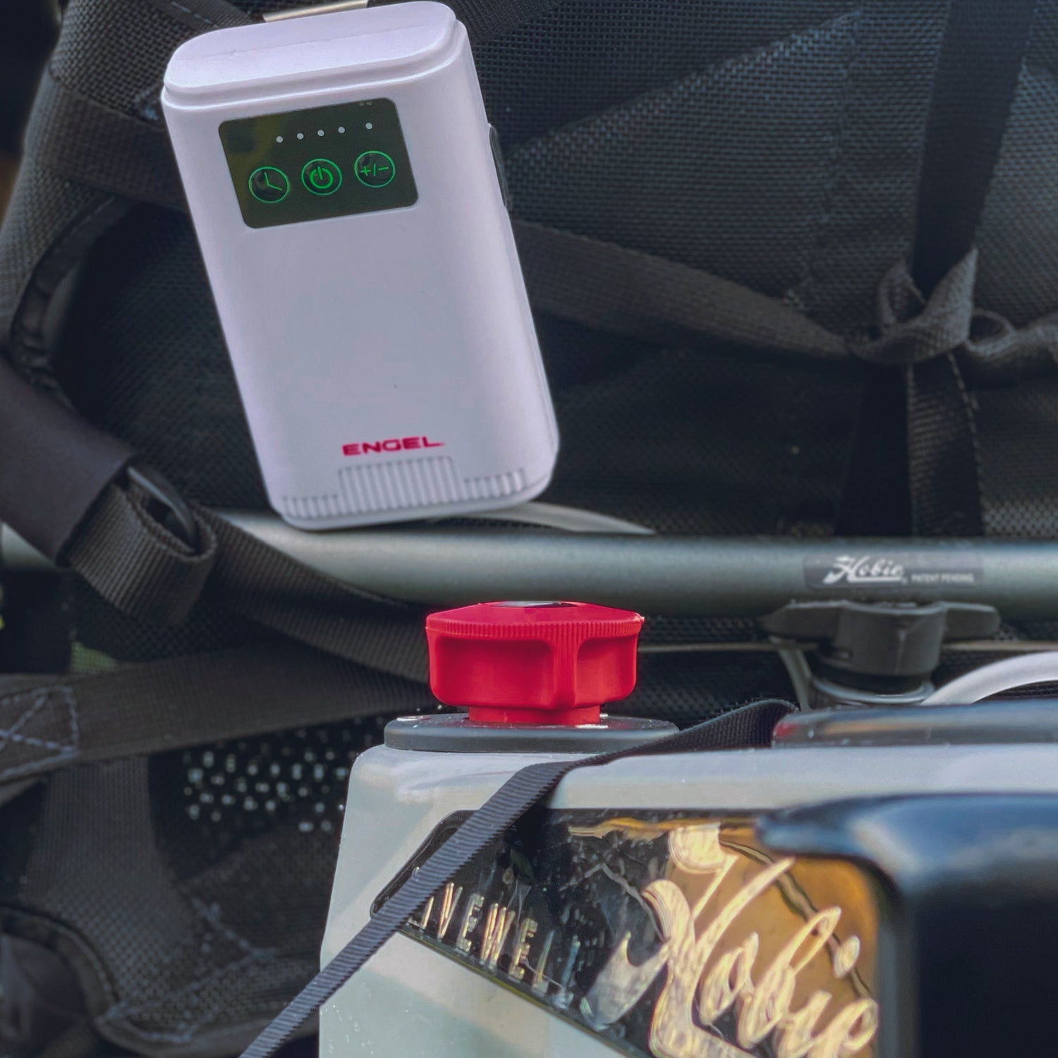 A Engel Coolers Engel Lithium-ion Rechargeable Live Bait Aerator Pump is attached to the back of a bike.