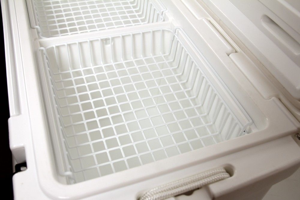 A white plastic coated container with a wire mesh inside - Engel Coolers Hanging Cooler Wire Basket